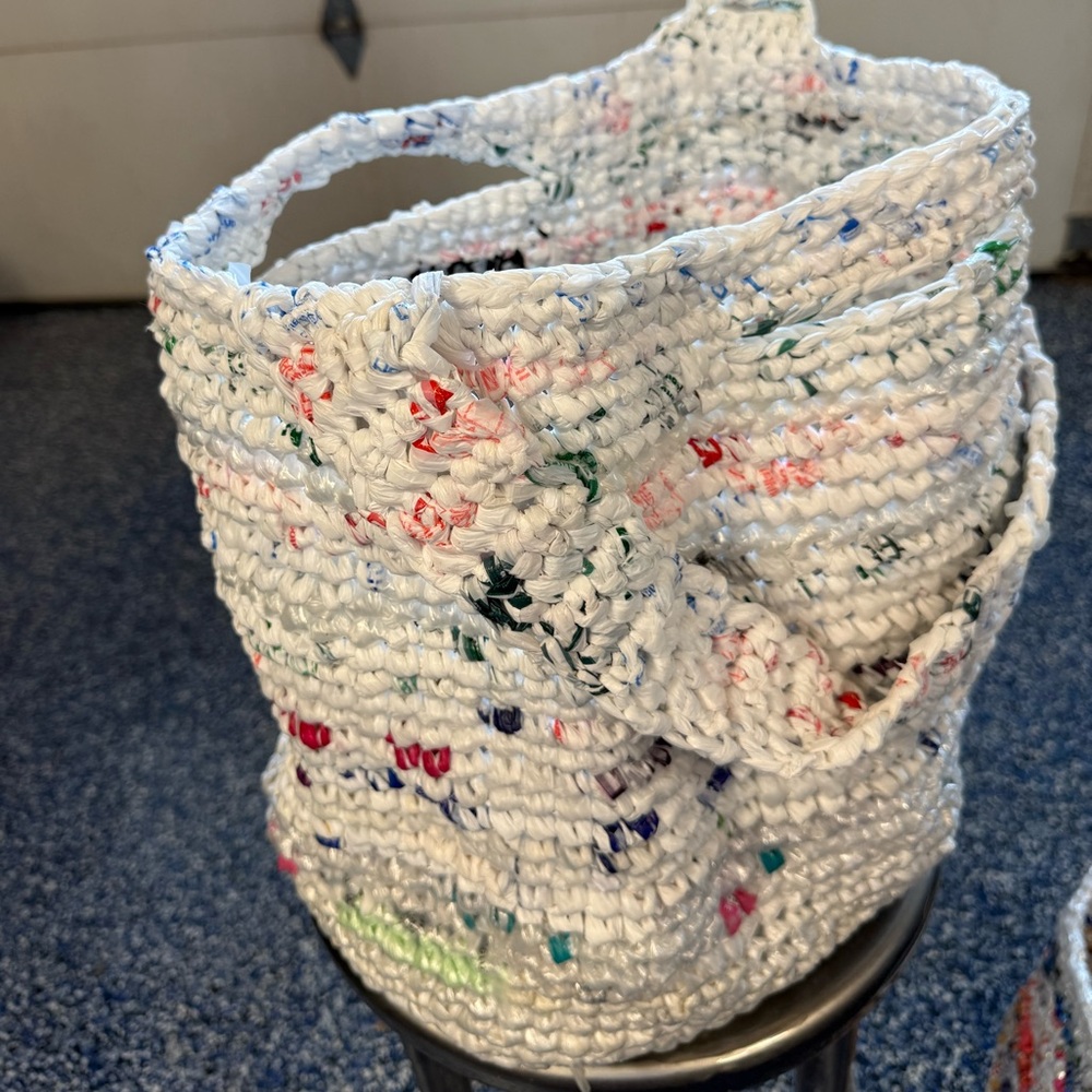 Handmade from plastic bags crocheted shopping tote bag with a pocket